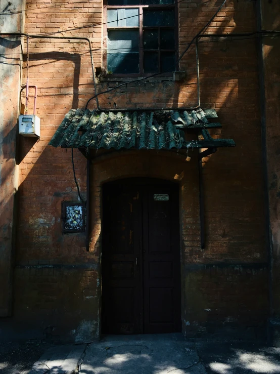 the entrance to an old brick building with a canopy