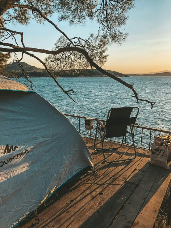 the view of the water with an rv tent in the foreground