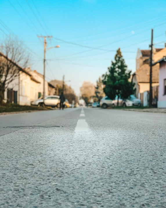 an empty city street, with little dles on the asphalt