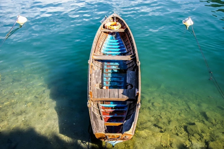 a canoe on the sea water in front of a pier