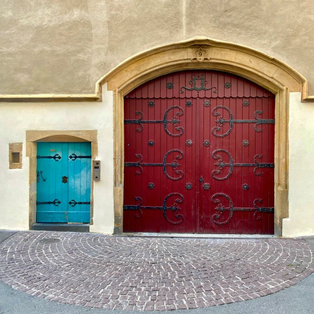 a large metal door sits in front of a building