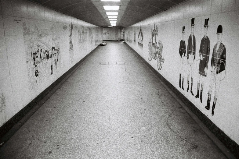 the wall of graffiti in the subway has writing on it