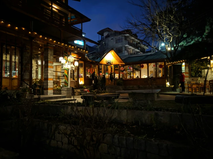 a lighted restaurant that is on the side of a road