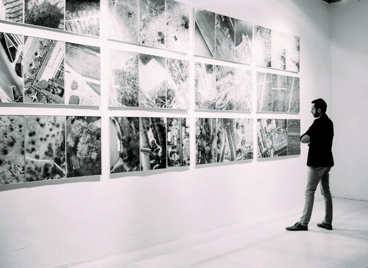 man standing in front of a display of art