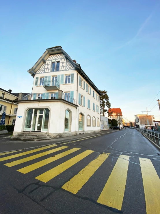 a yellow crosswalk in front of an apartment building