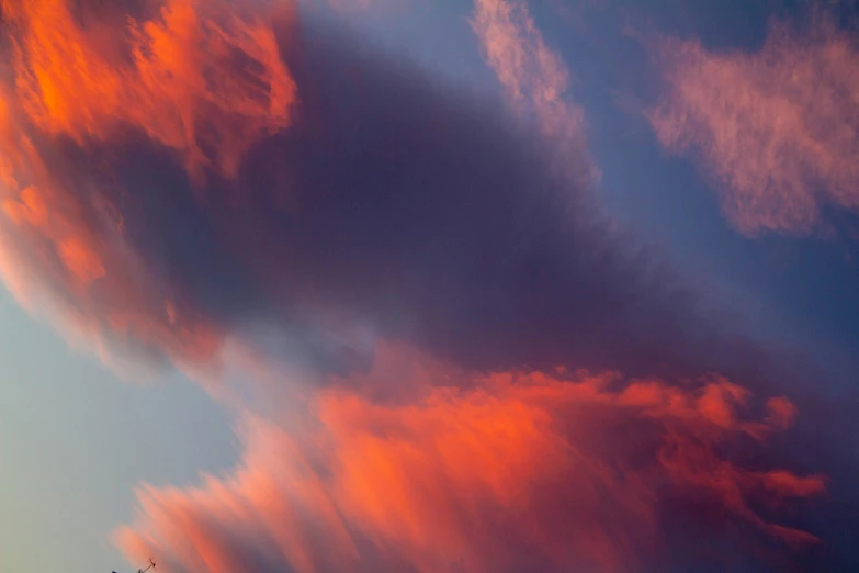 a large airplane flies in the sky during sunset