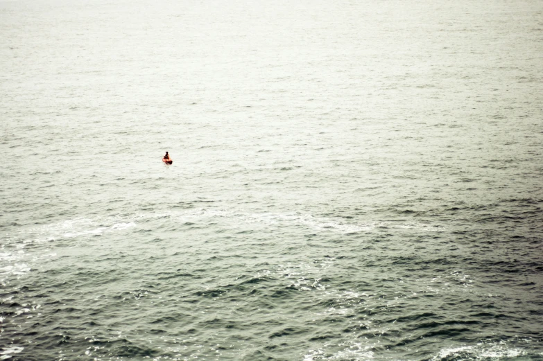 an image of a small boat sailing in the ocean