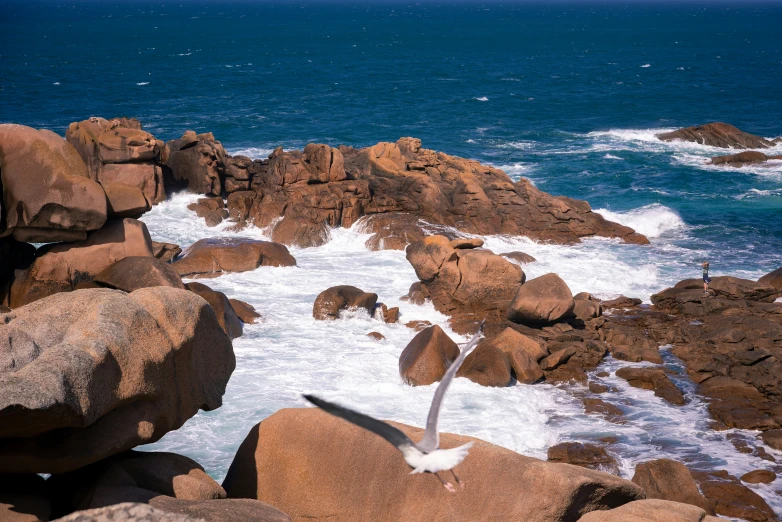 an image of waves crashing on a rocky shoreline