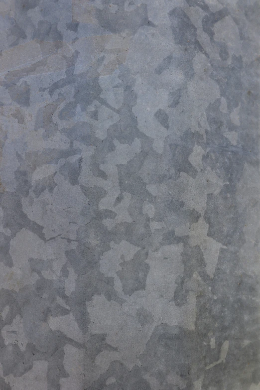 grey concrete that is covered with small, speckled gray spots