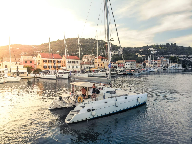 boats are sitting in the harbor during sunset