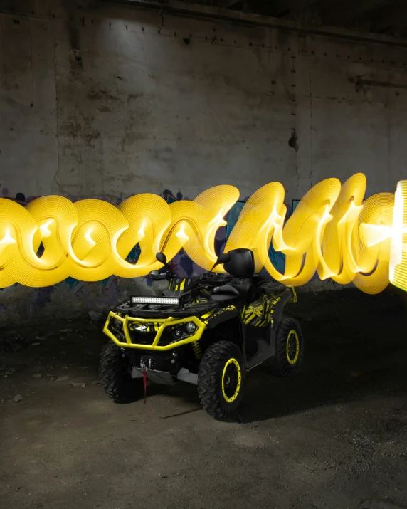 the atv has many yellow wheels and a helmet on it