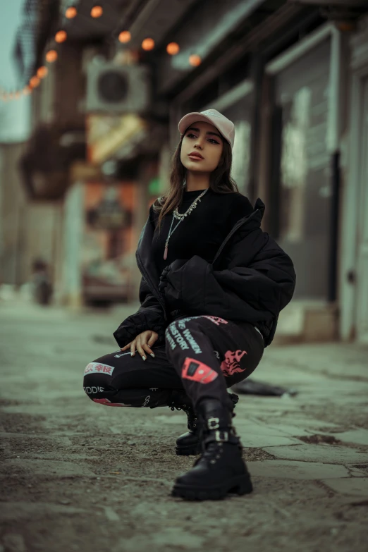 a young woman is sitting on a city sidewalk