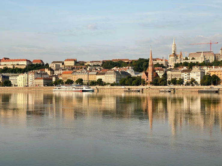 boats are seen along a river near a city