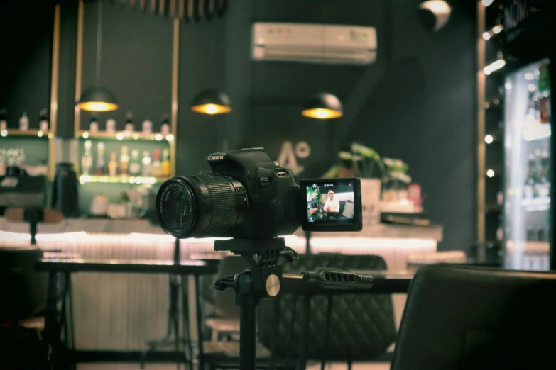 a camera with a tripod next to it in a bar