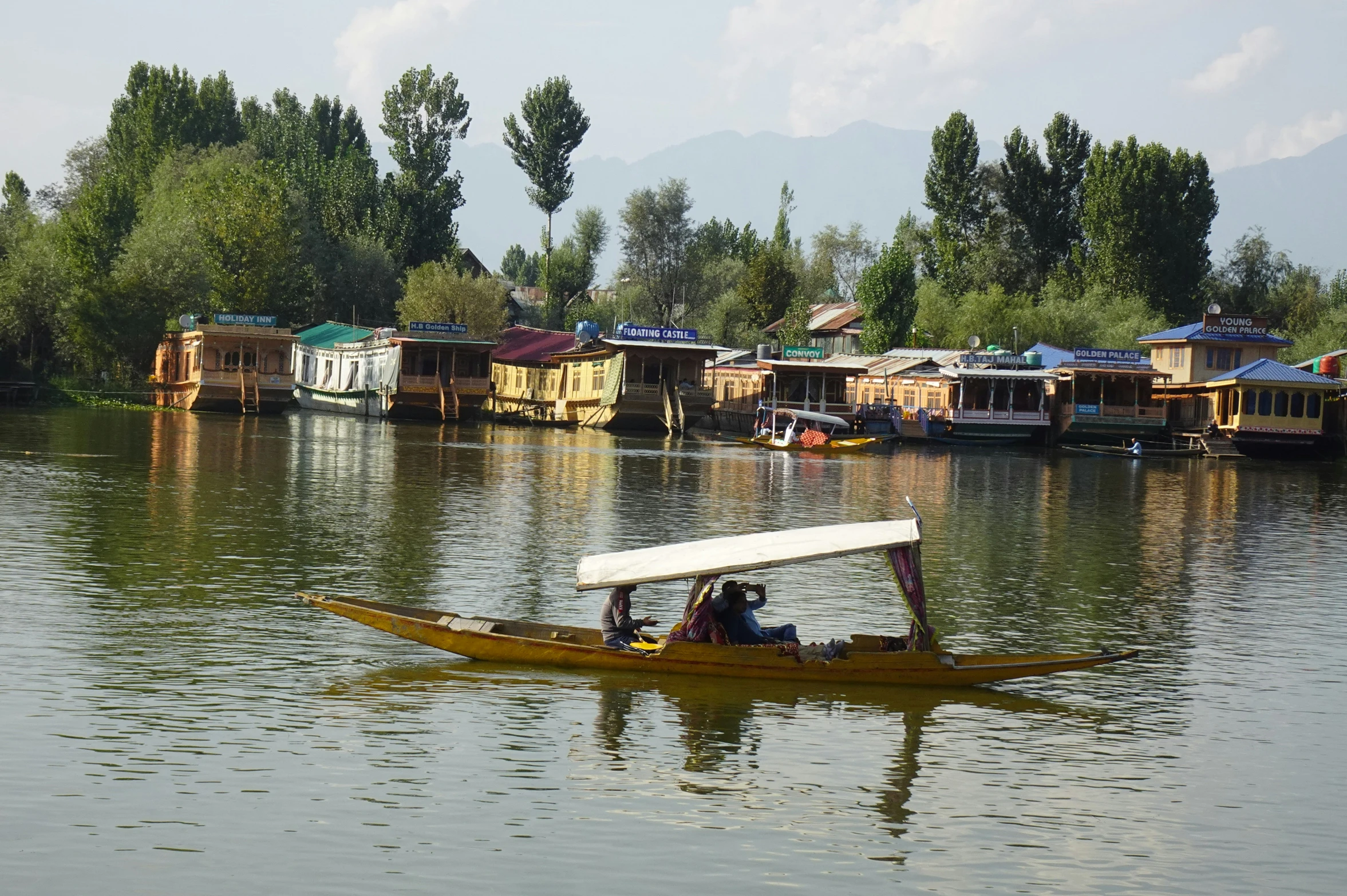 a canoe with people in the water paddling it