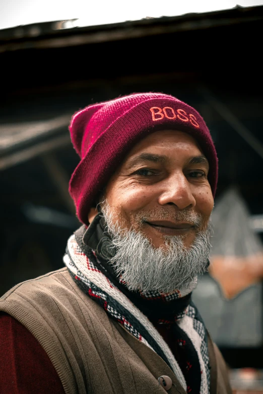 a man with a beard is smiling for the camera