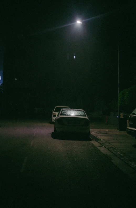 a car parked on a driveway at night