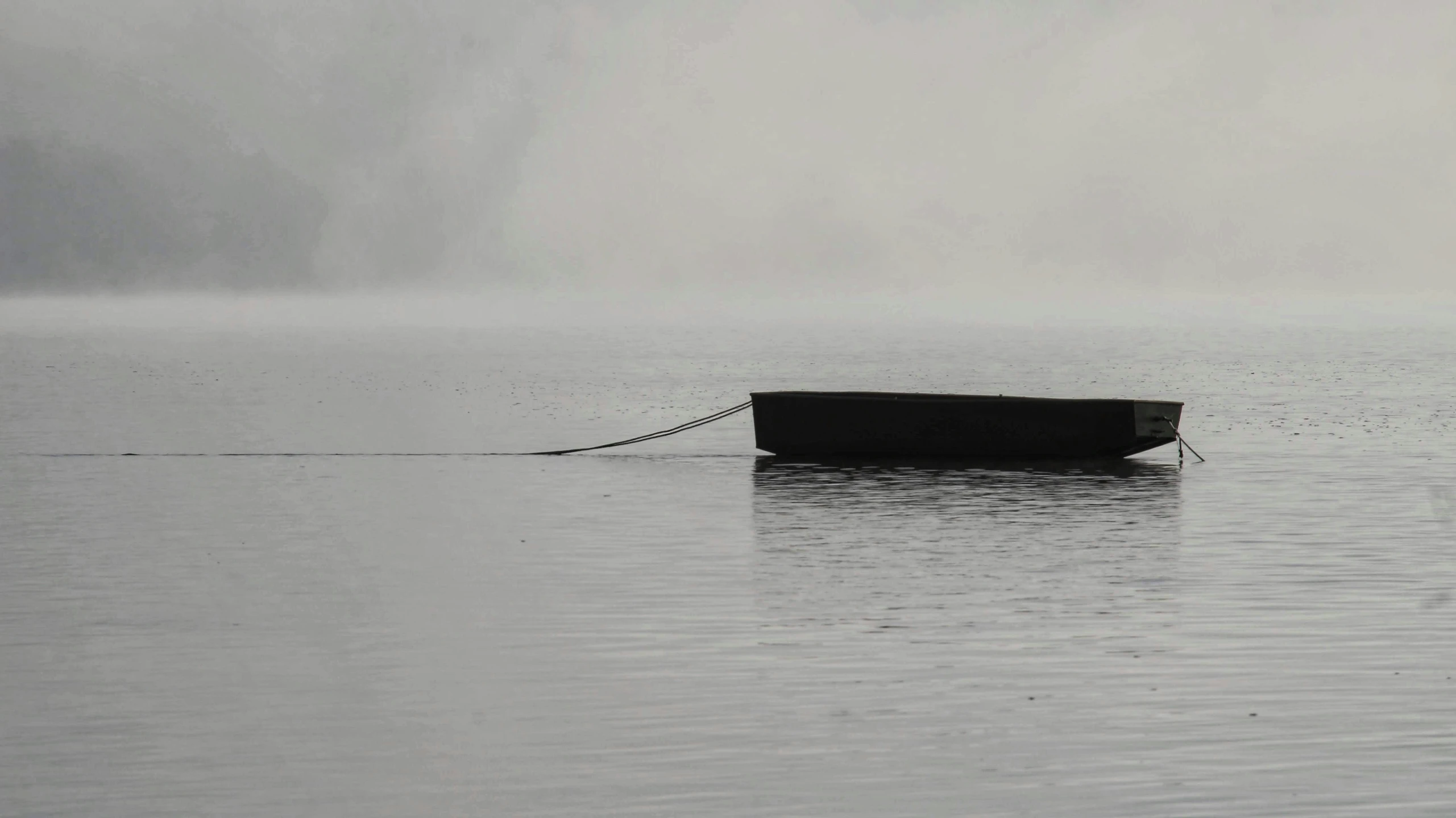 the view of a boat at sea on a foggy day