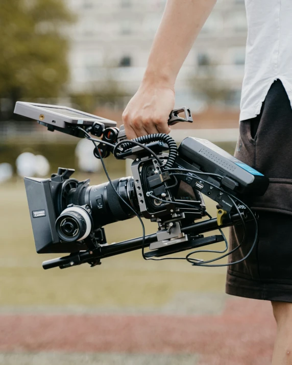 the person holds a camera behind their shoulder