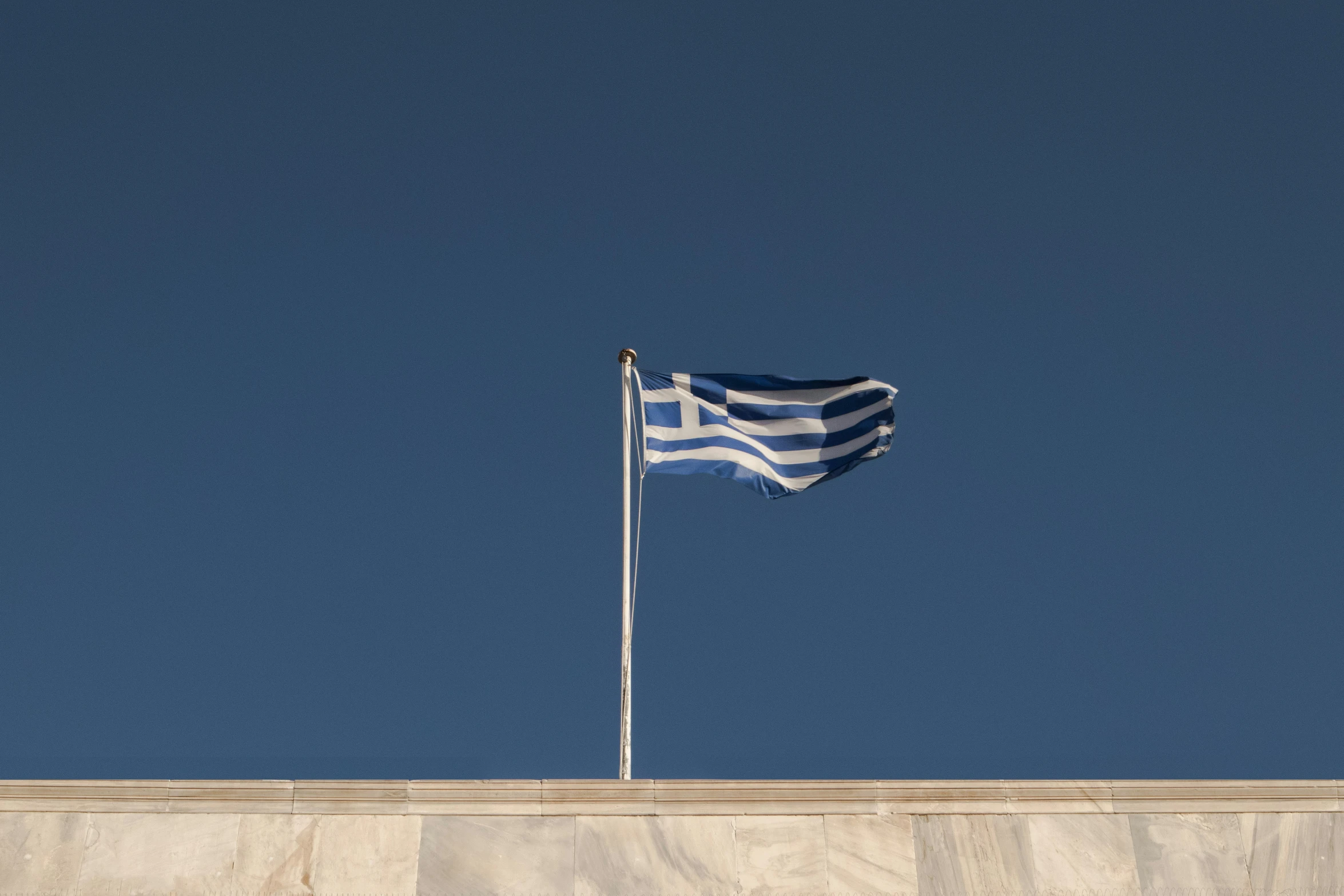 the flag of greece waving in the wind