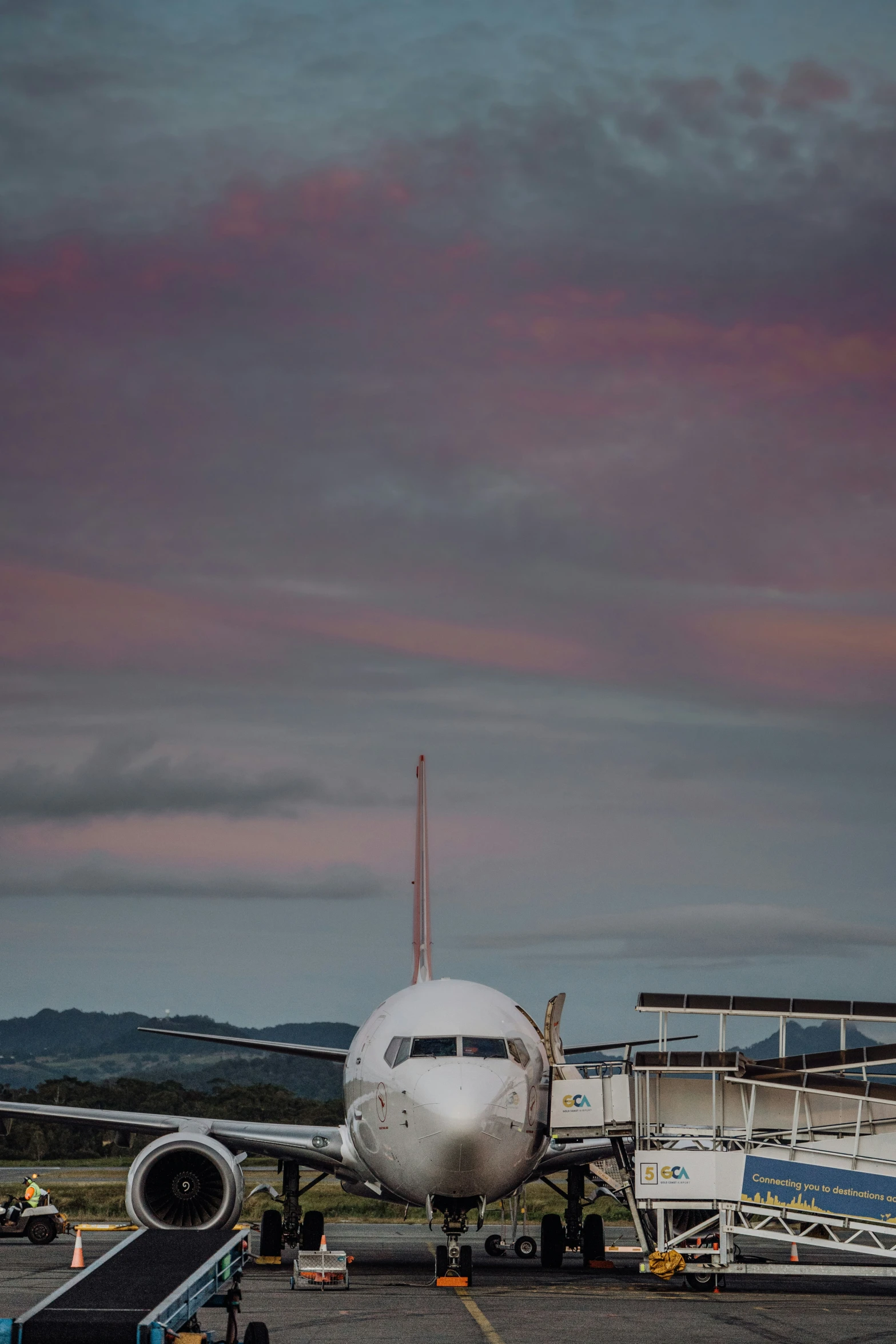 an airplane sitting in an airport with a sky background