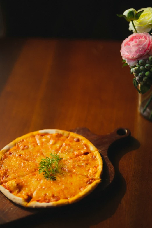 an orange pie is on a small wood board