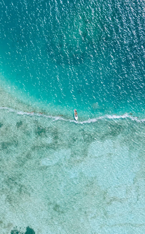 a couple people riding a wave on top of the ocean