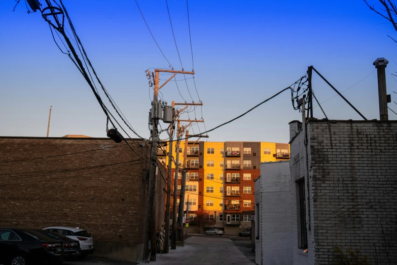 power lines and buildings line the urban street