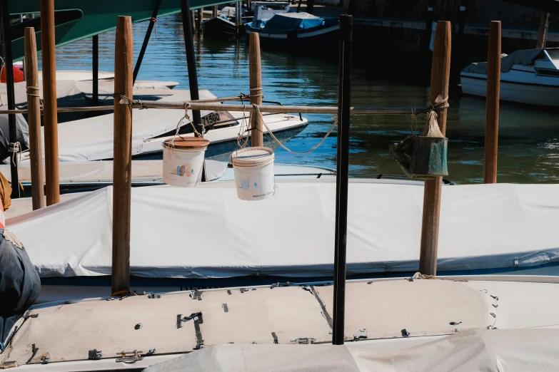 a harbor with boats, sand and seaweed next to the docks