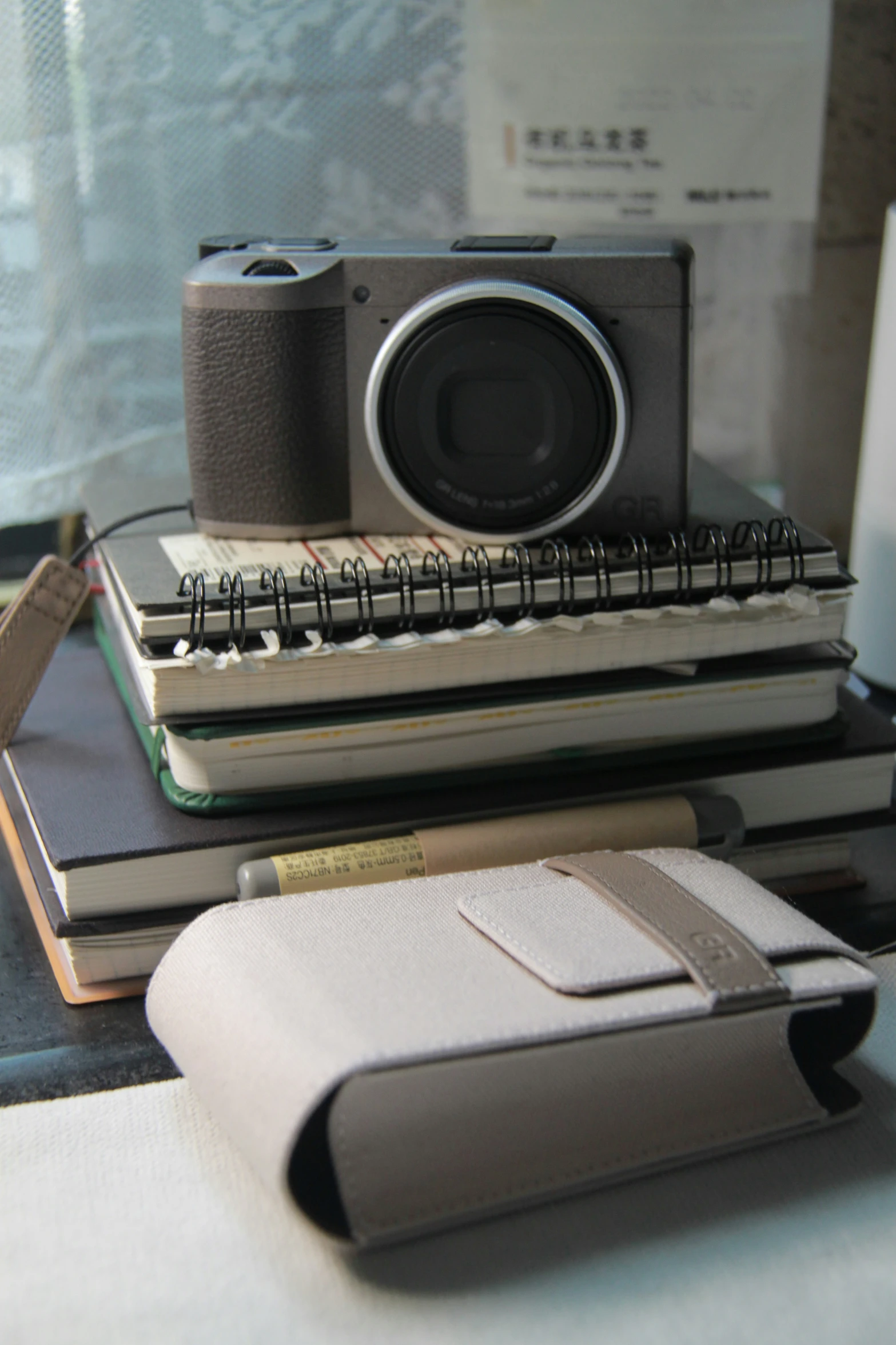 some books and a camera on a desk