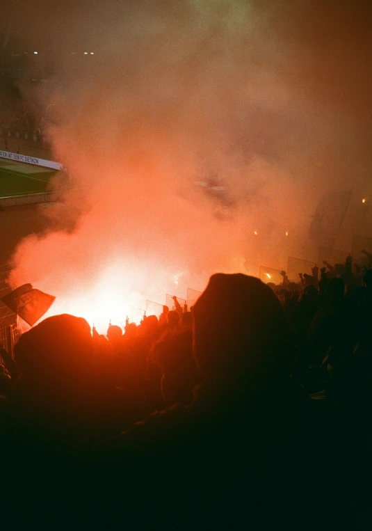 a large bonfire lit at night during an outdoor event