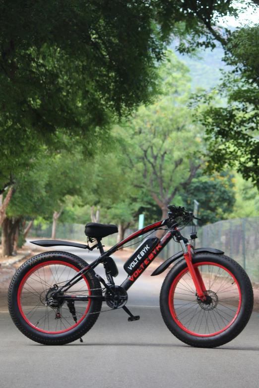 a bike parked on the side of the street with a tree in the background