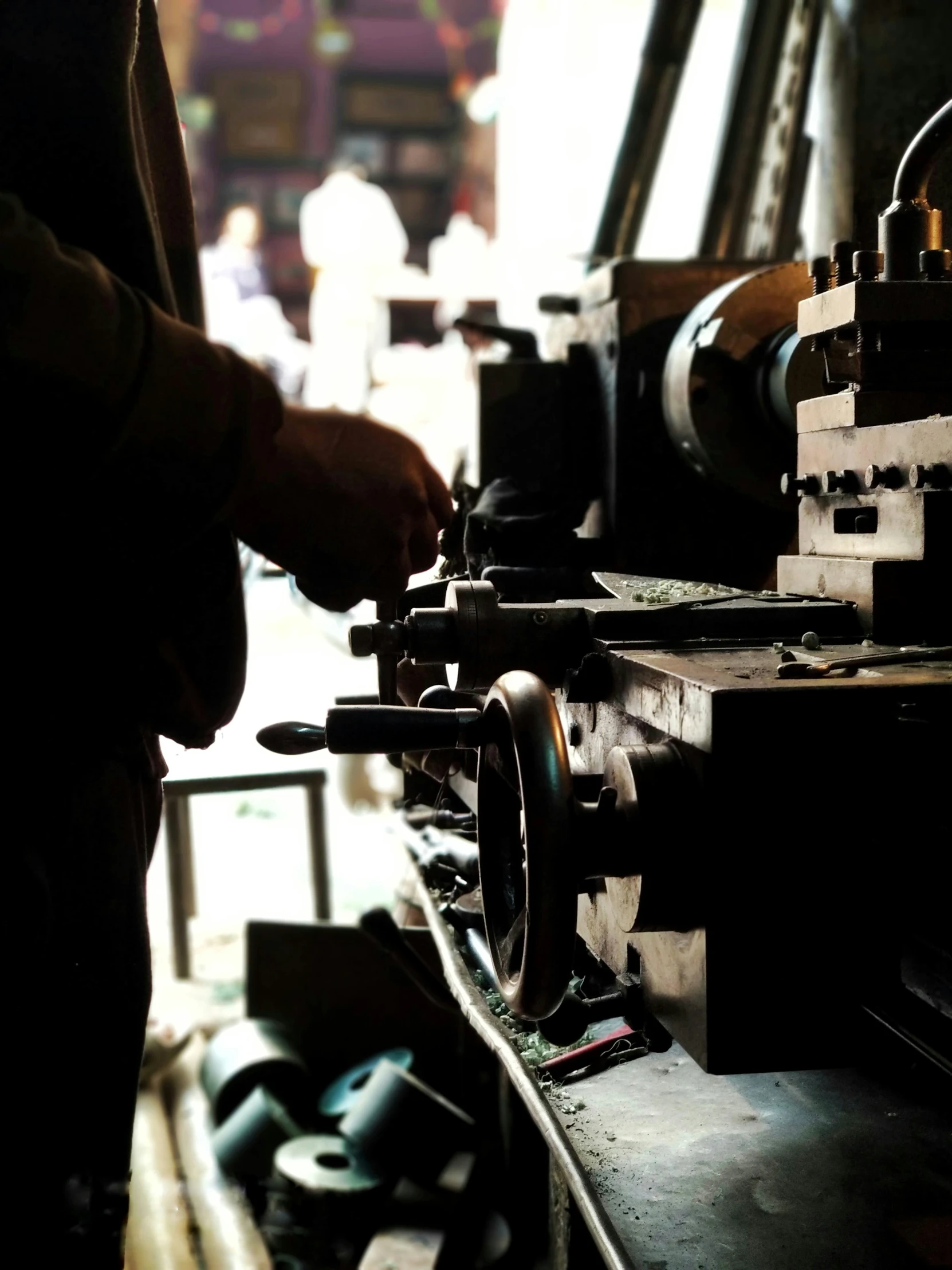 a person with one hand working on a metal object