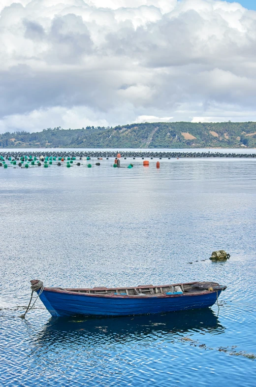 a boat is floating in a calm blue lake