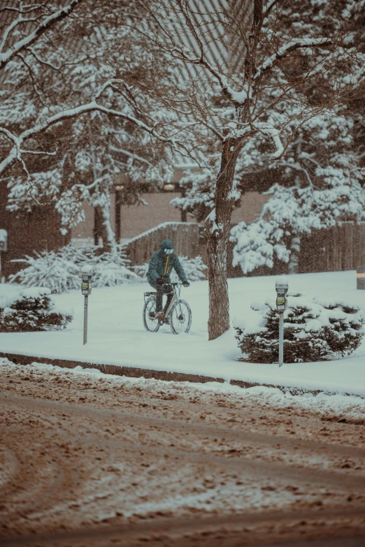 a man riding his bike in a snowy park