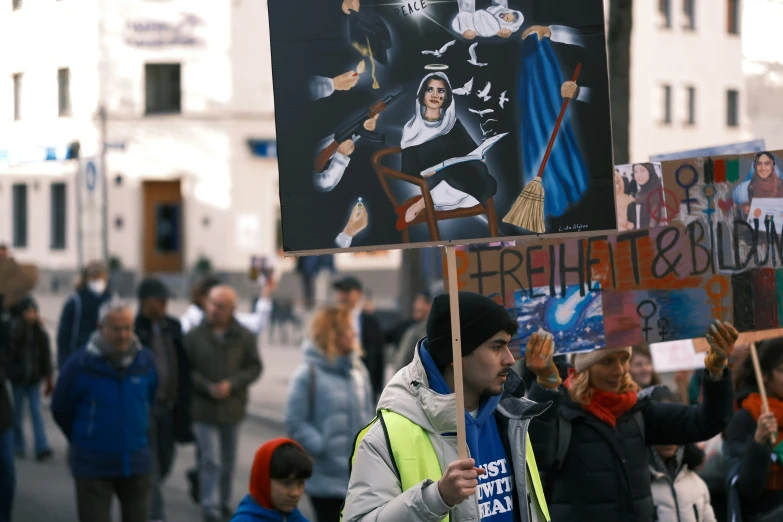 a man is holding a sign that reads no justice