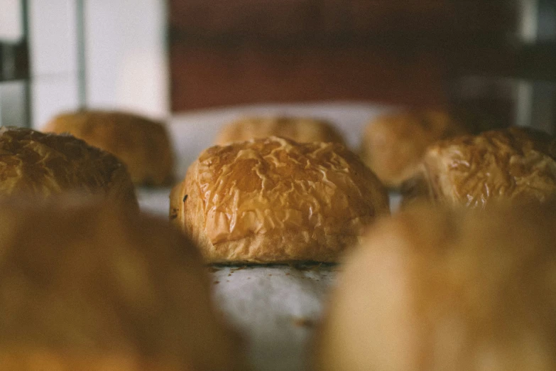 a baker is putting fresh baked food into the oven