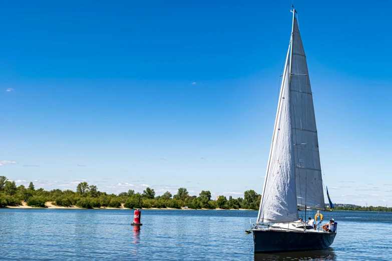 a small sailboat floating on top of a lake