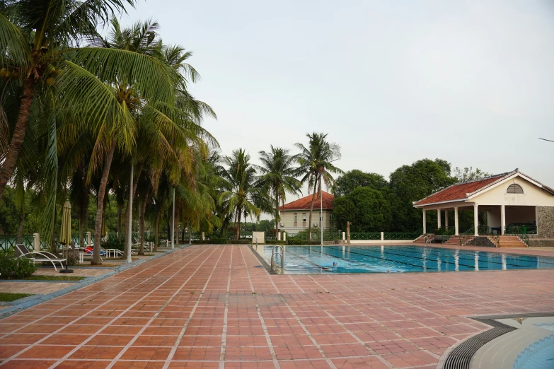 a couple of pools and trees outside of the building