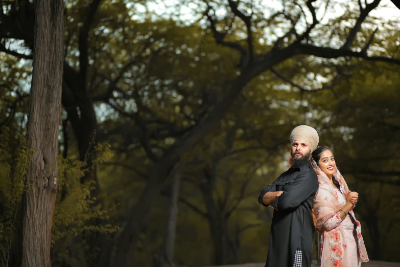 a couple is hugging outside in the fall