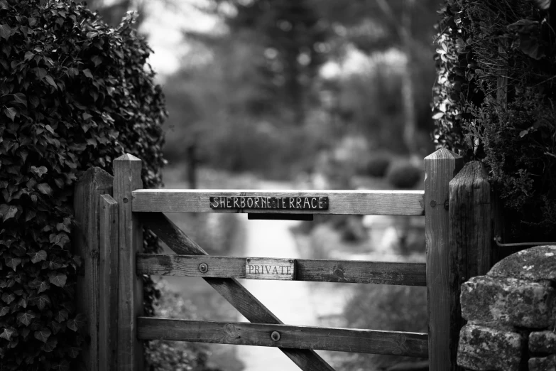 a wooden fence with a wooden gate on the right