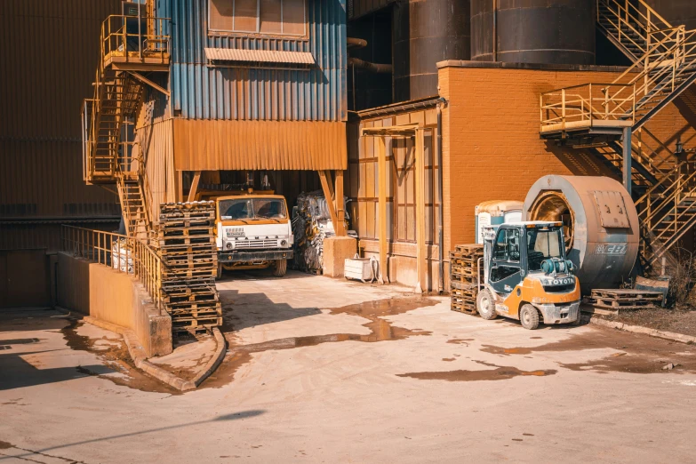 two trucks and a car parked outside a warehouse