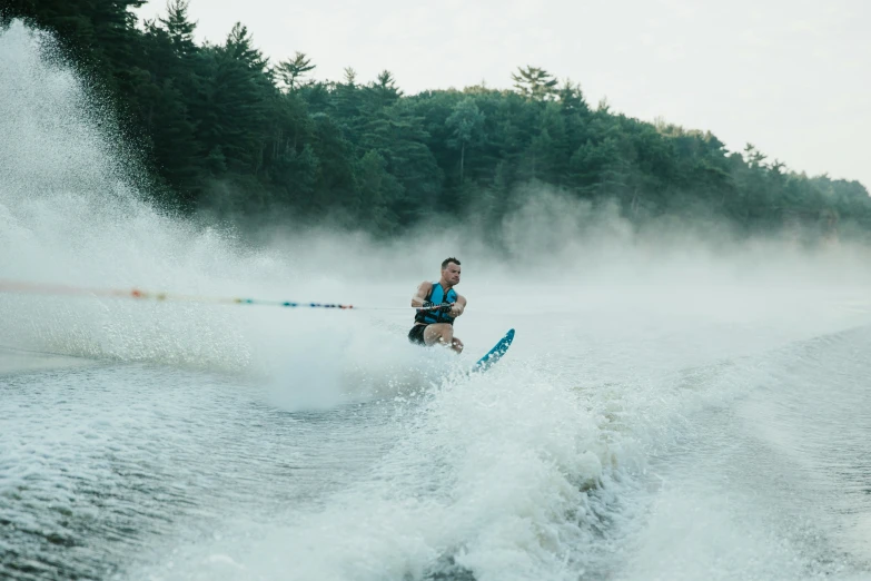 the person is skiing on the lake with very strong waters