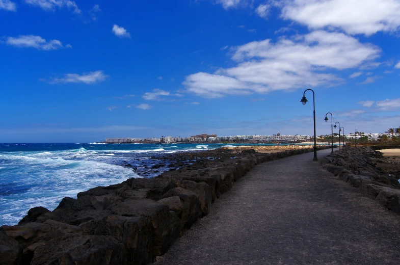 an empty road leading to the water's edge