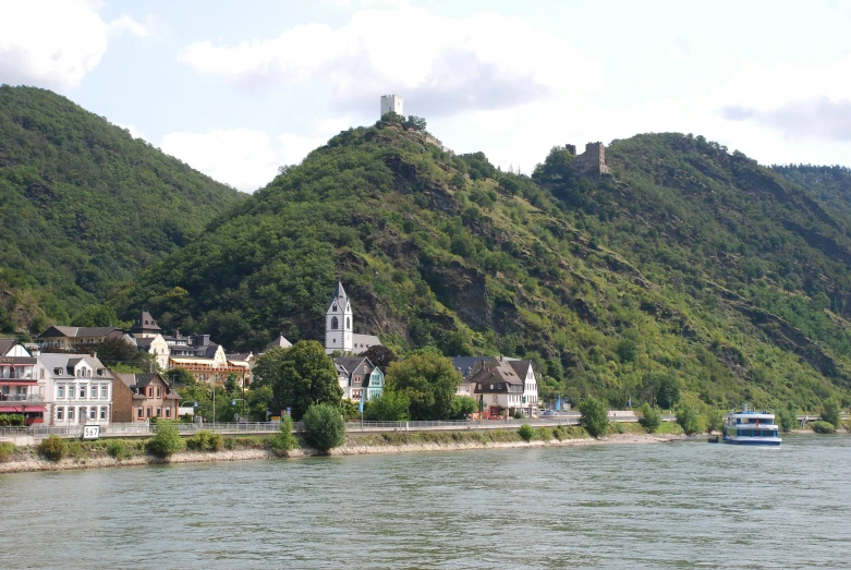 the small island is near the river with boats on it