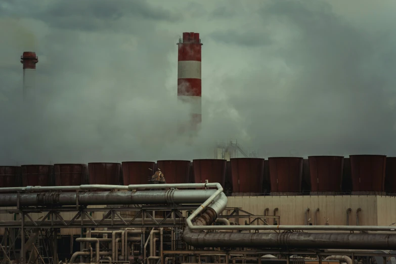 a smokestack and pipe system blowing out steam