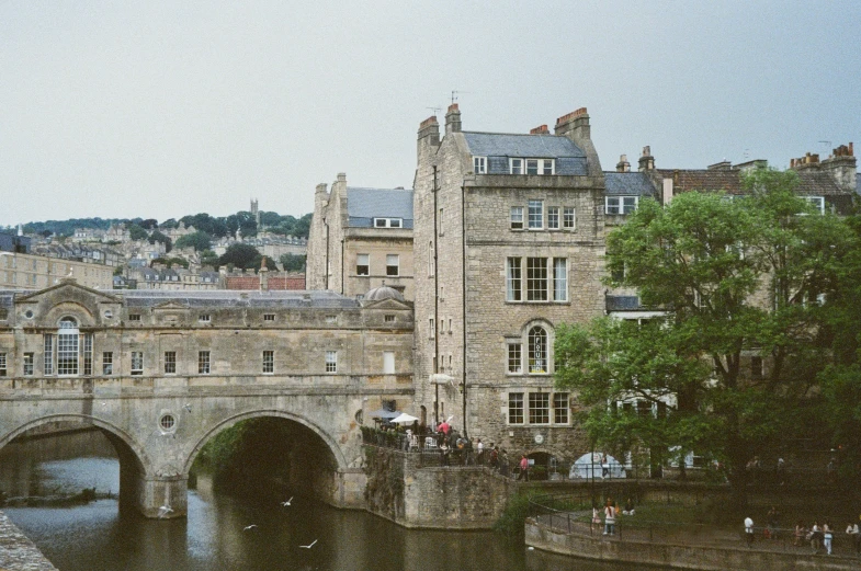 an old bridge is spanning a body of water