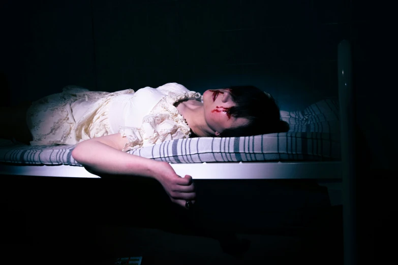 a man sleeping on a bed that is in the dark