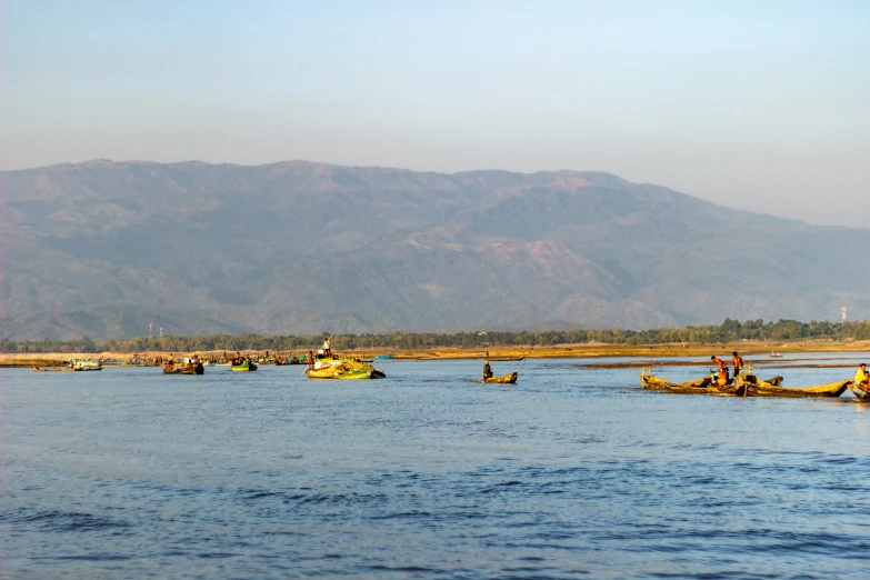 a group of people in canoes floating on a lake