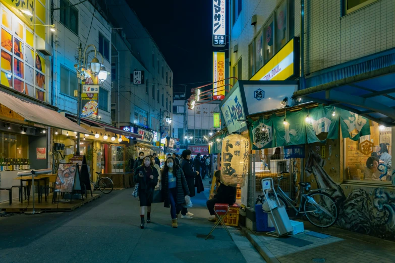 people are shopping in a large city at night